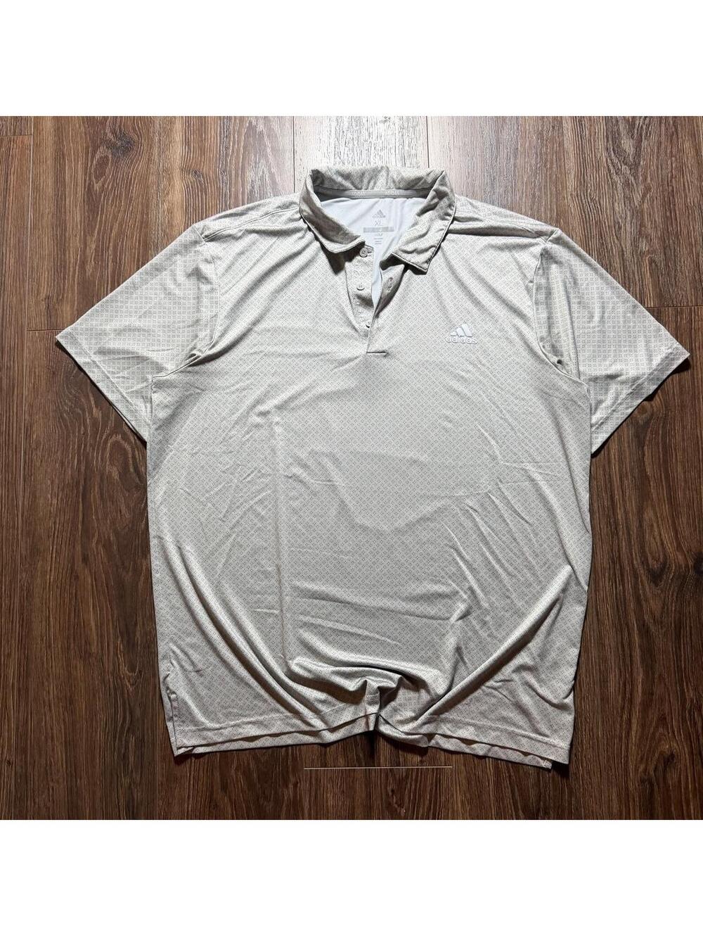 Adidas Golf performance polo in a clean light gray micro-dot pattern.